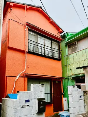 a colorful building with crates in front of it at Green & Orange House - Economic APT in Tokyo Tranquil Block, with Direct Access to Ginza & Akihabara in Tokyo