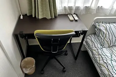 a desk with a chair next to a bed at Warmhome-hirai2F in Tokyo