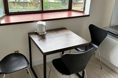 a small table with two chairs and a window at Warmhome-hirai2F in Tokyo