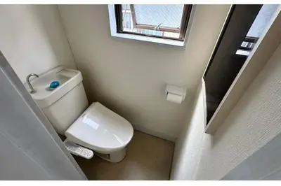 a small bathroom with a toilet and a mirror at Warmhome-hirai2F in Tokyo