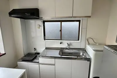 a small kitchen with a sink and a window at Warmhome-hirai3F in Tokyo