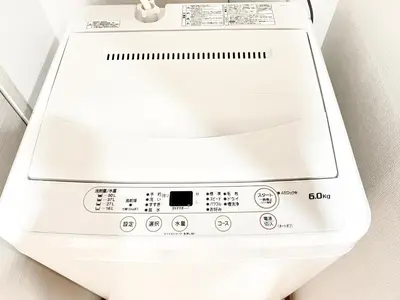 a white washing machine sitting on a wall at Shinjuku City, 2 Double Beds Apt, Free WiFi in Tokyo