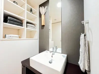 a bathroom with a white sink and a mirror at Shinjuku City, 2 Double Beds Apt, Free WiFi in Tokyo