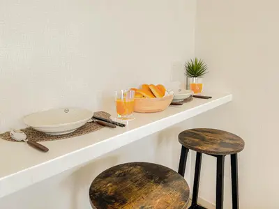 a shelf with a bowl of bread and two stools at Shinjuku City, 2 Double Beds Apt, Free WiFi in Tokyo