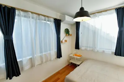 a bedroom with black and white curtains and a bed at GM3442 Three-story Japanese-style villa in Shinjuku in Tokyo