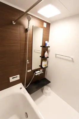 a bathroom with a tub and a sink and a mirror at GM3442 Three-story Japanese-style villa in Shinjuku in Tokyo