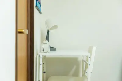 a white desk with a lamp on top of it at Garfield home Shinjuku in Tokyo