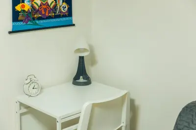 a white desk with a lamp on top of it at Garfield home Shinjuku in Tokyo