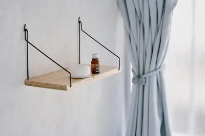 a wooden shelf on a wall with a bottle of medicine at Cosmo in Tokyo