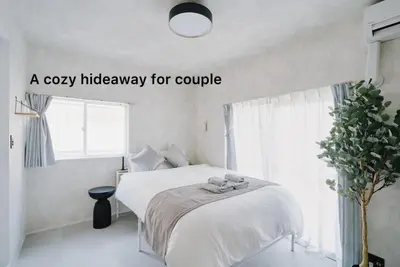 a bedroom with a bed with a cozy hideaway for couple at Cosmo in Tokyo