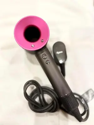 a pink hair dryer next to a black cord at Ginza 401 in Tokyo