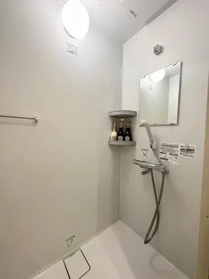 a bathroom with a mirror and a shelf with bottles at Ginza 201,Tsukiji 3 mins,Tsukiji Market in Tokyo