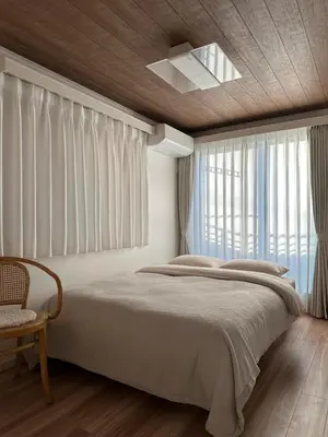 a bedroom with a large bed and a window at Wasabi Box House - Ikebukuro Area in Tokyo