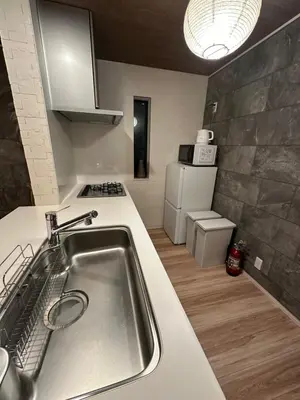 a kitchen with a sink and a counter top at Wasabi Box House - Ikebukuro Area in Tokyo