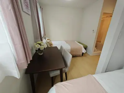 a room with a table and a room with two beds at Nerima house NR0250 in Tokyo