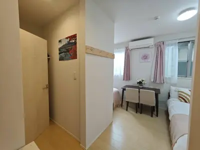 a bedroom with a table and a bed and a dining room at Nerima house NR0250 in Tokyo