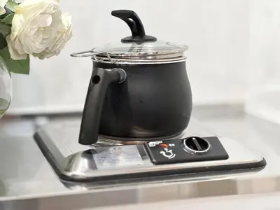 a tea kettle on top of a stove with a cell phone at Nerima house NR0250 in Tokyo