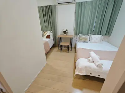a small room with two beds and a table at Nerima house NR0250 in Tokyo