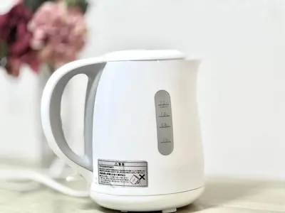 a white electric kettle sitting on a table at Nerima house NR0250 in Tokyo