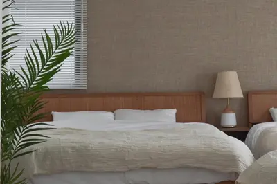 a bedroom with a bed and a plant and a window at Prinets Shinjuku Building - Vacation STAY 17728 in Tokyo