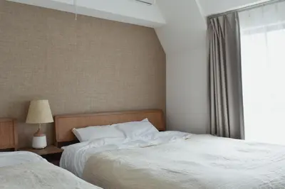 a bedroom with two beds and a window at Prinets Shinjuku Building - Vacation STAY 17728 in Tokyo