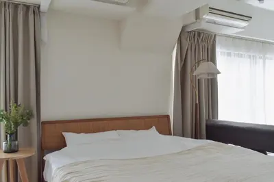 a bedroom with a white bed and a window at Prinets Shinjuku Building - Vacation STAY 17728 in Tokyo