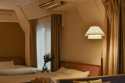 a hotel room with two beds and a lamp and a window at Prinets Shinjuku Building - Vacation STAY 17728 in Tokyo
