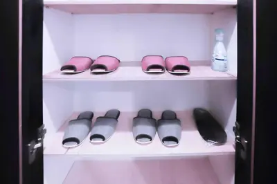 a closet with someones shoes and a bottle of water at yuga hotel tokiwadai in Tokyo