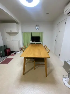 a large room with a table and a piano at Tokyo Shibya 88 Shared House in Tokyo