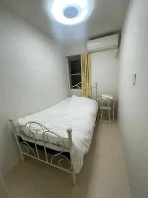 a small bedroom with a bed and a window at Tokyo Shibya 88 Shared House in Tokyo
