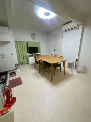 a dining room with a wooden table and chairs at Tokyo Shibya 88 Shared House in Tokyo