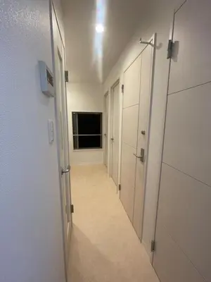 a hallway with white lockers and a hallway with a door at Tokyo Shibya 88 Shared House in Tokyo