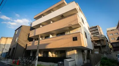 a tall building with at Karabiner House Hikihune in Tokyo