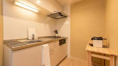 a small kitchen with a sink and a counter at Karabiner House Hikihune in Tokyo