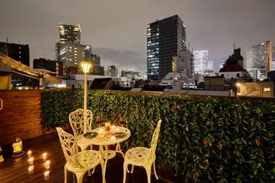 a table and chairs on a balcony with a city skyline at Spacious 80sqm Apt near Shibuya Crossing, 8 min walk to Shibuya Station in Tokyo