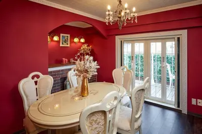 a dining room with red walls and a table and chairs at Spacious 80sqm Apt near Shibuya Crossing, 8 min walk to Shibuya Station in Tokyo