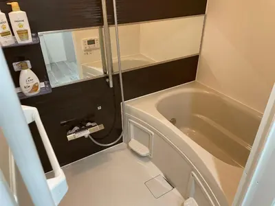a small bathroom with a tub and a sink at COMMA HOUSE Otsuka 102 in Tokyo