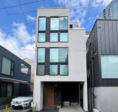 a white house with black windows at Second Home KANAMECHO in Tokyo
