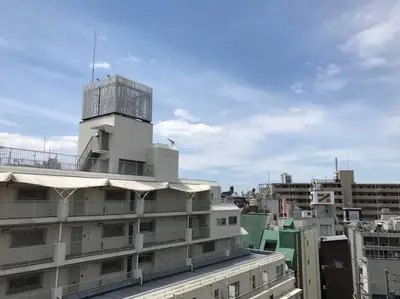 a building with a control tower on top of it at unito \u9053\u7384\u5742\u90b8\u5b85 in Tokyo