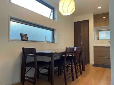 a dining room with a table with chairs and a window at \u30b5\u30af\u30e9 in Tokyo