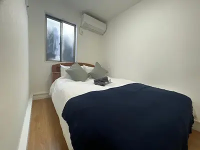 a bedroom with a large bed with two pillows at \u30b5\u30af\u30e9 in Tokyo
