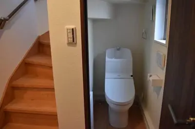 a bathroom with a white toilet in a staircase at \u30b5\u30af\u30e9 in Tokyo