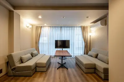 a living room with two couches and a television at \u30b0\u30e9\u30b9\u30ad\u30e3\u30d3\u30f3\u6d5c\u677e\u753aaw Second and third floors in Tokyo