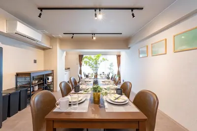 a dining room with a long table and chairs at \u30d6\u30e9\u30f3\u30d9\u30fc\u30b9\u6771\u4eac\u516d\u7fa9\u5712 ss in Tokyo