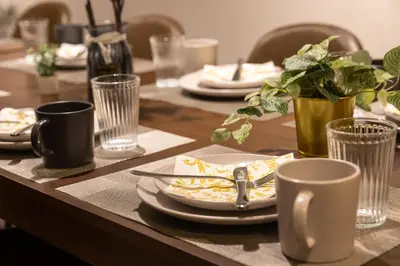 a wooden table with plates and cups on it at \u30d6\u30e9\u30f3\u30d9\u30fc\u30b9\u6771\u4eac\u516d\u7fa9\u5712 aw in Tokyo