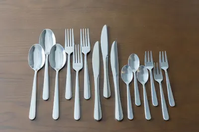a group of silver spoons and forks and knives at \u30d6\u30e9\u30f3\u30d9\u30fc\u30b9\u6771\u4eac\u516d\u7fa9\u5712 aw in Tokyo