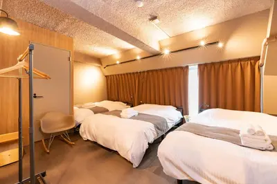a room with three beds and a window at \u30d6\u30e9\u30f3\u30d9\u30fc\u30b9\u6771\u4eac\u516d\u7fa9\u5712 aw in Tokyo