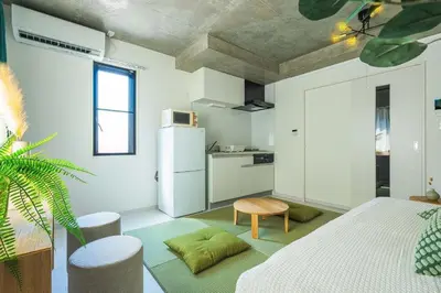 a kitchen with a white refrigerator and a table at AT Asakusa in Tokyo