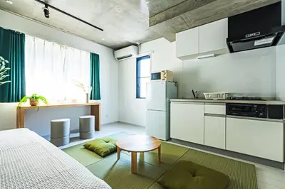 a kitchen with a bed and a table in a room at AT Asakusa in Tokyo