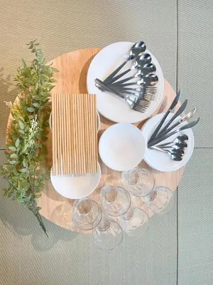 a table with plates and utensils on a table at AT Asakusa in Tokyo
